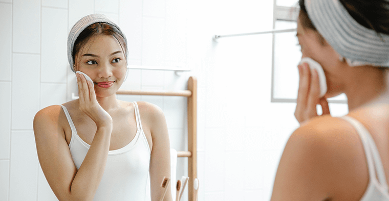 A woman removing makeup